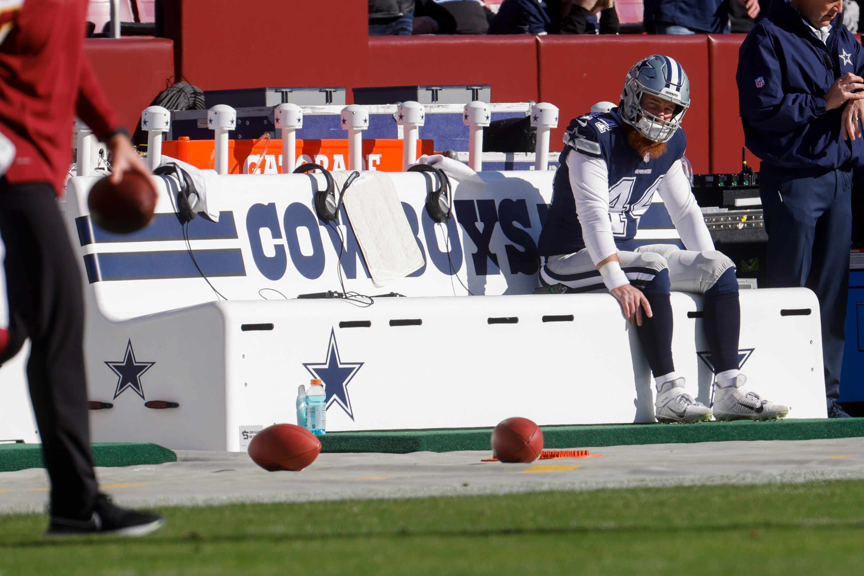 Dallas Cowboys long snapper Jake McQuaide (44) sits on the Cowboys bench before the start of...