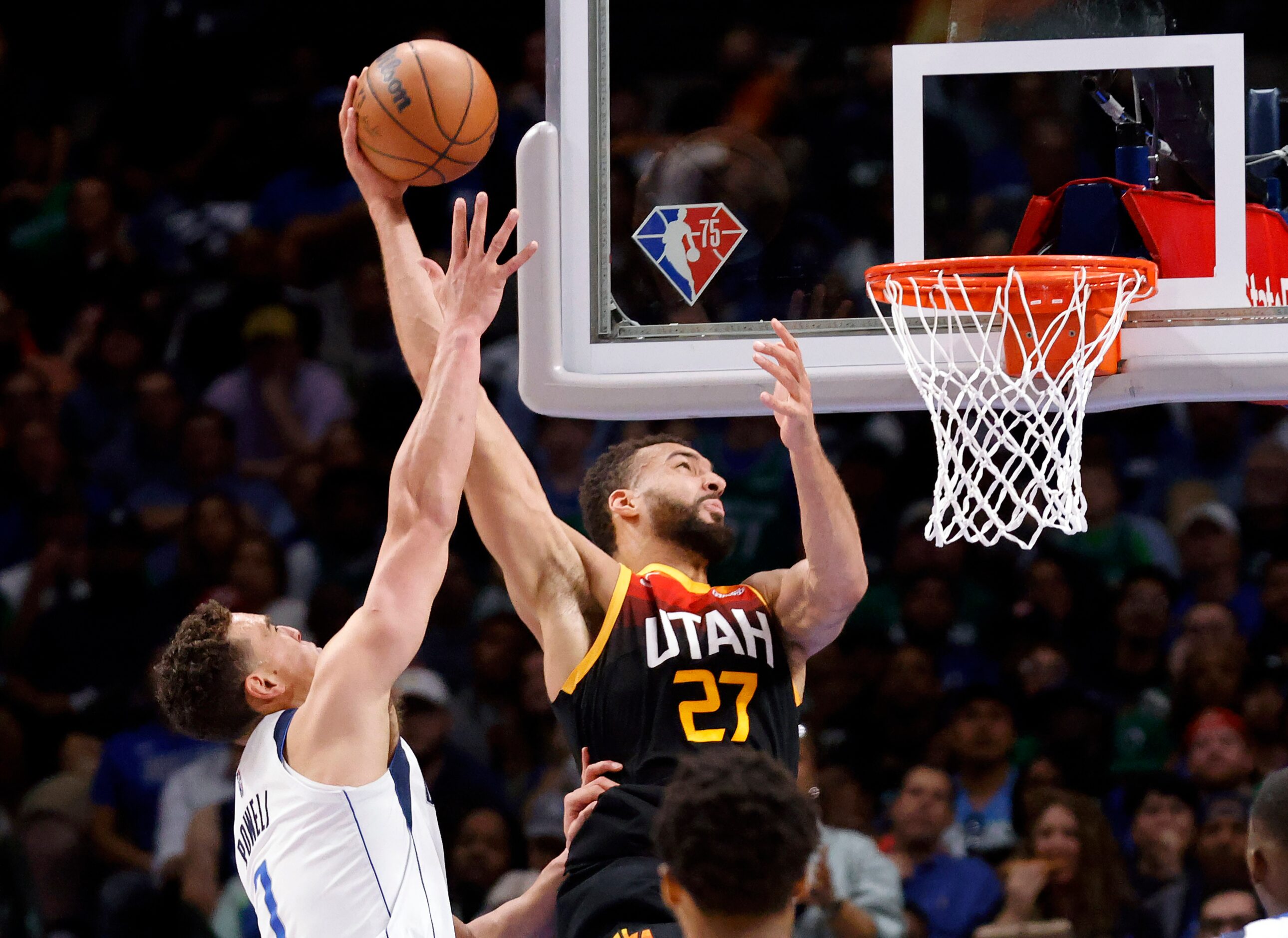 Dallas Mavericks center Dwight Powell (7) hacks Utah Jazz center Rudy Gobert (27) as he put...