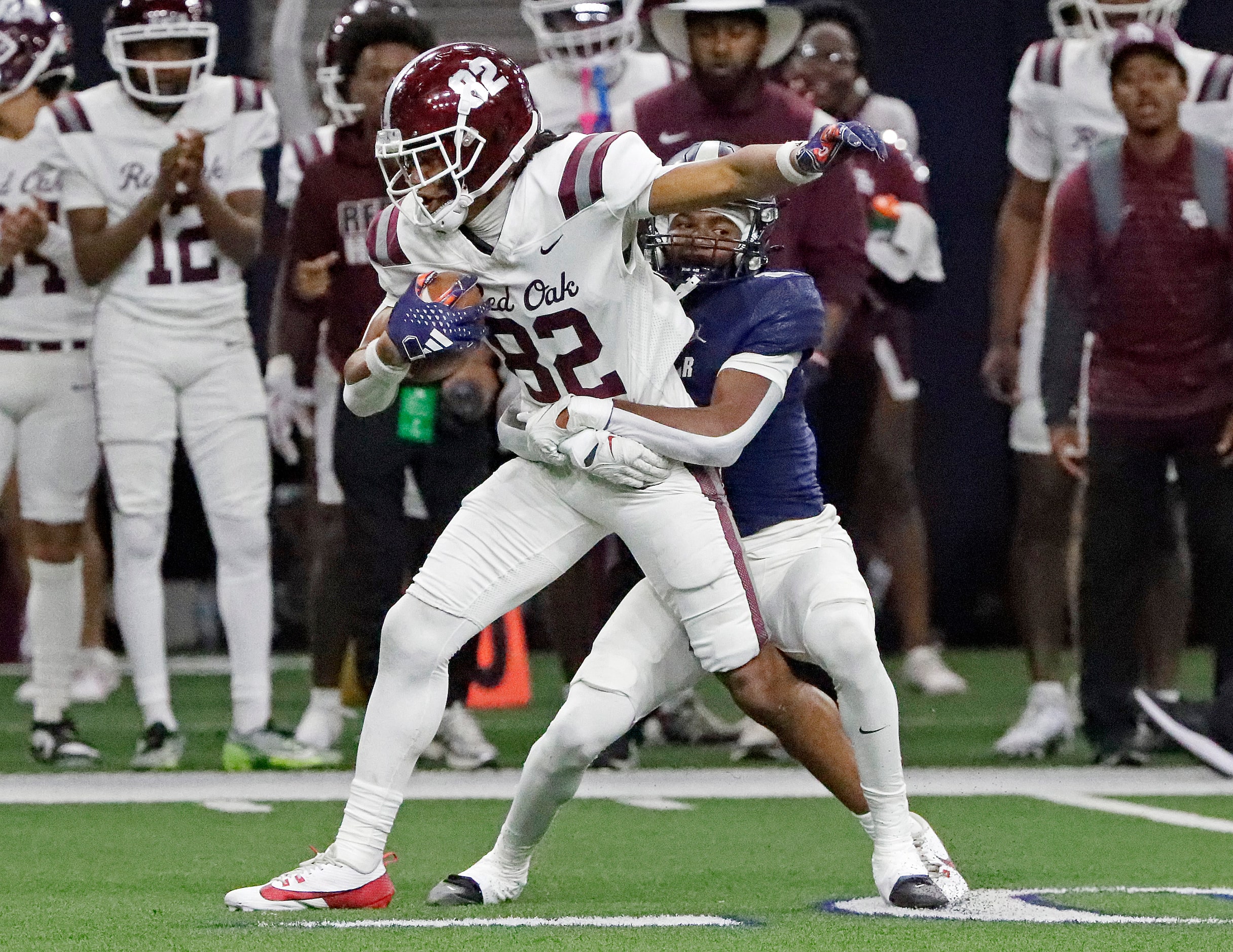 Red Oak High School tight end Dayon Jackson (82) drags Lone Star High School defensive back...