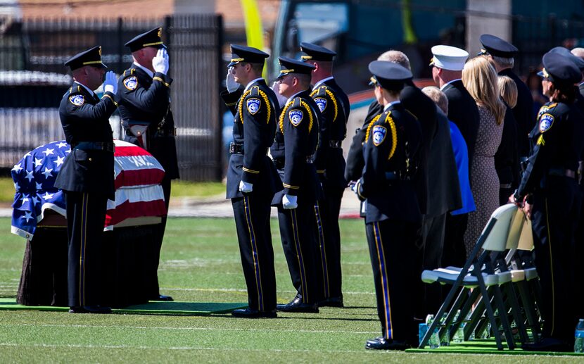  Officers salute a casket casket containing the body of Euless police officer David Hofer.