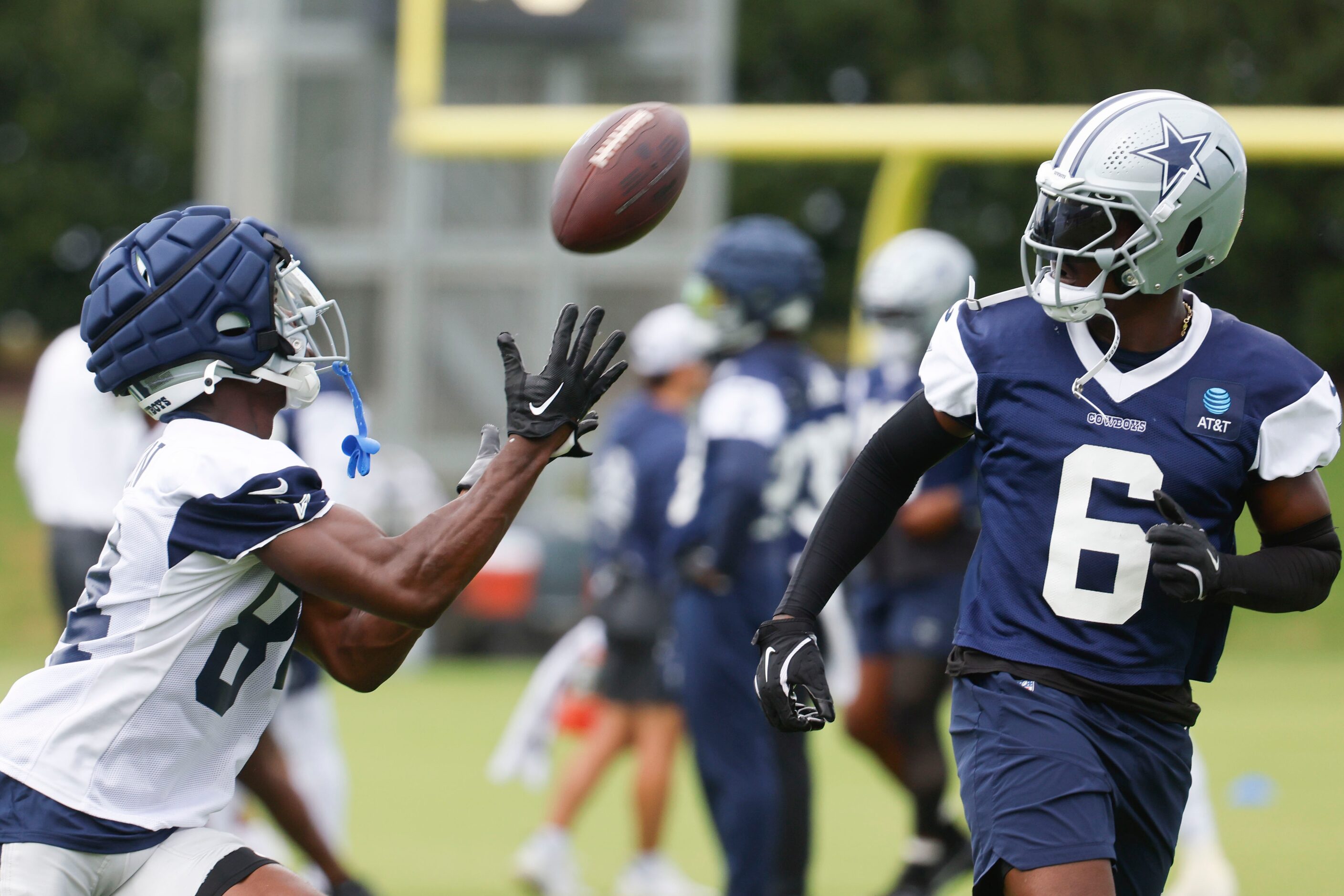 Dallas Cowboys wide receiver Kelvin Harmon (84) receives a pass as safety Donovan Wilson (6)...