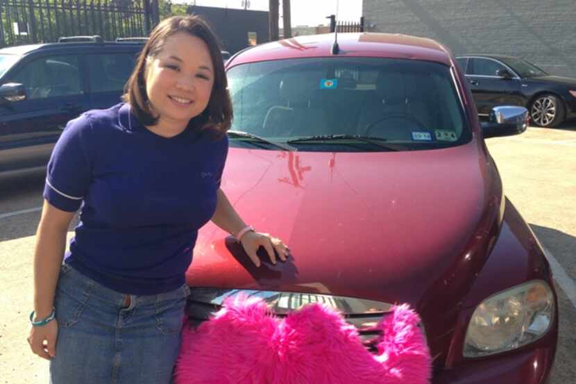 Lyft driver Jennifer Clark with her car adorned with a pink mustache.