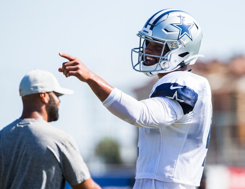 Dallas Cowboys quarterback Dak Prescott (4) points to running back Tony Pollard (36) during...