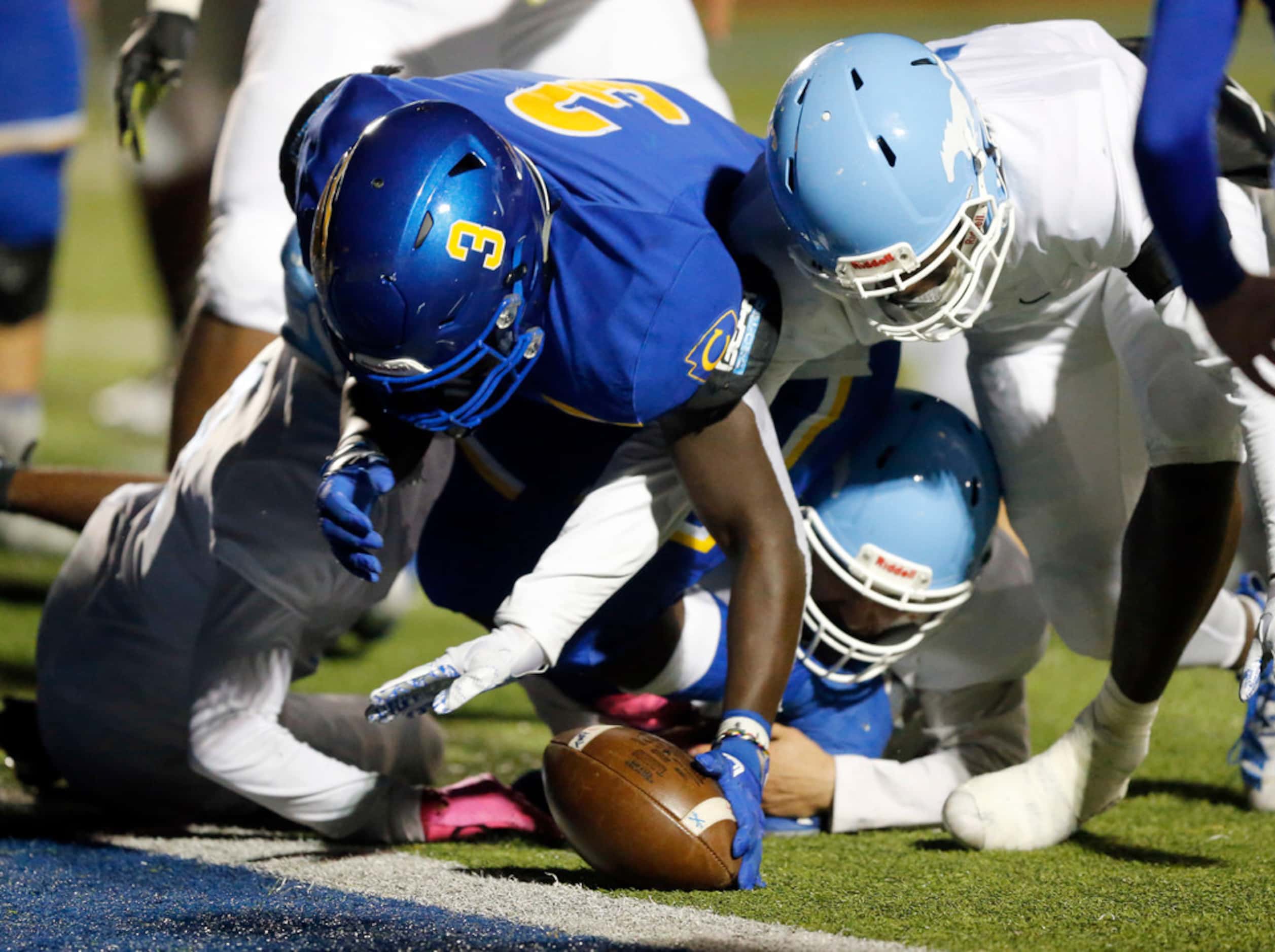 Community High David Obamehinti (3) dives for a fumble in the end zone after teammate Tyson...