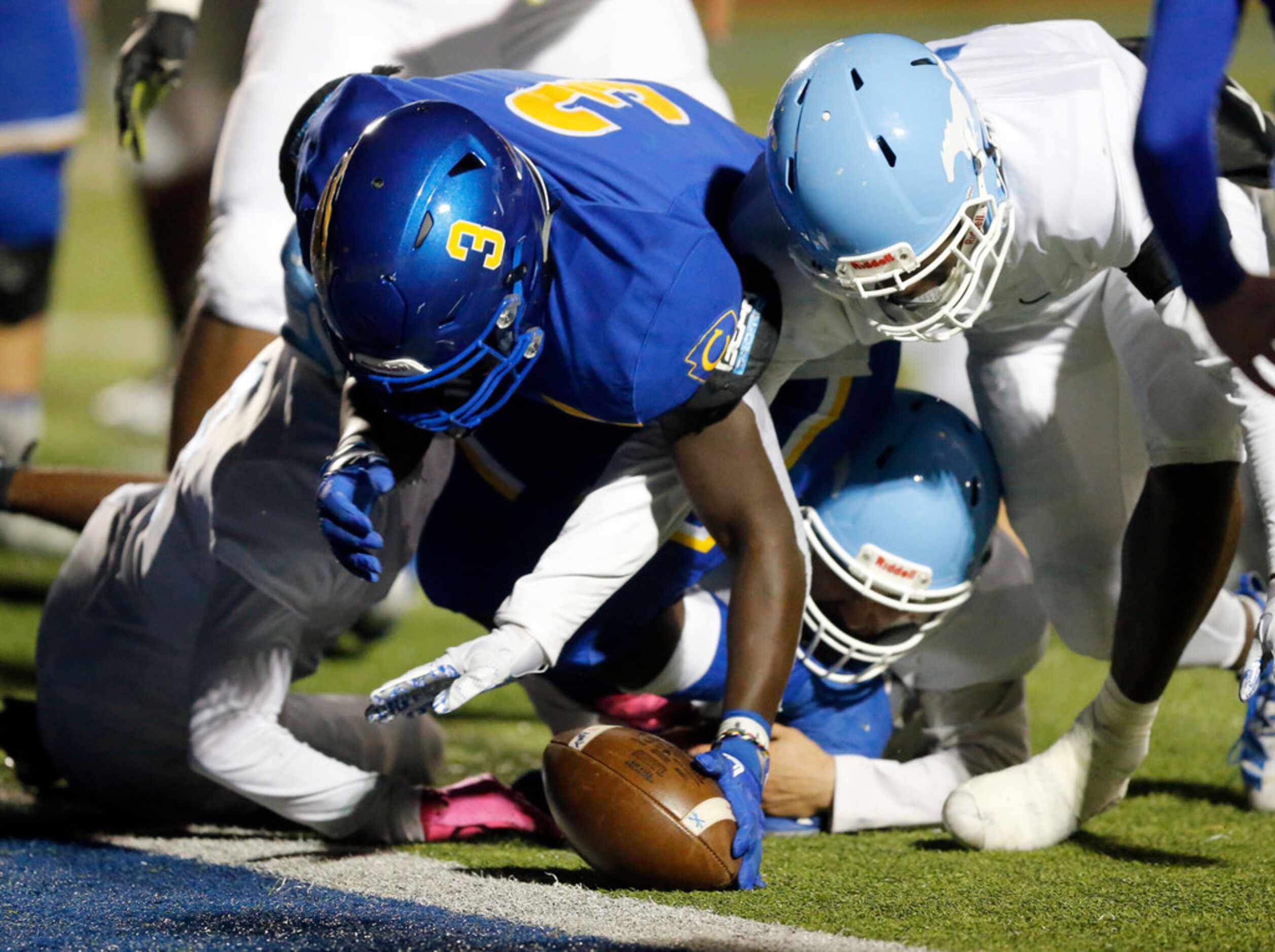 Community High David Obamehinti (3) dives for a fumble in the end zone after teammate Tyson...