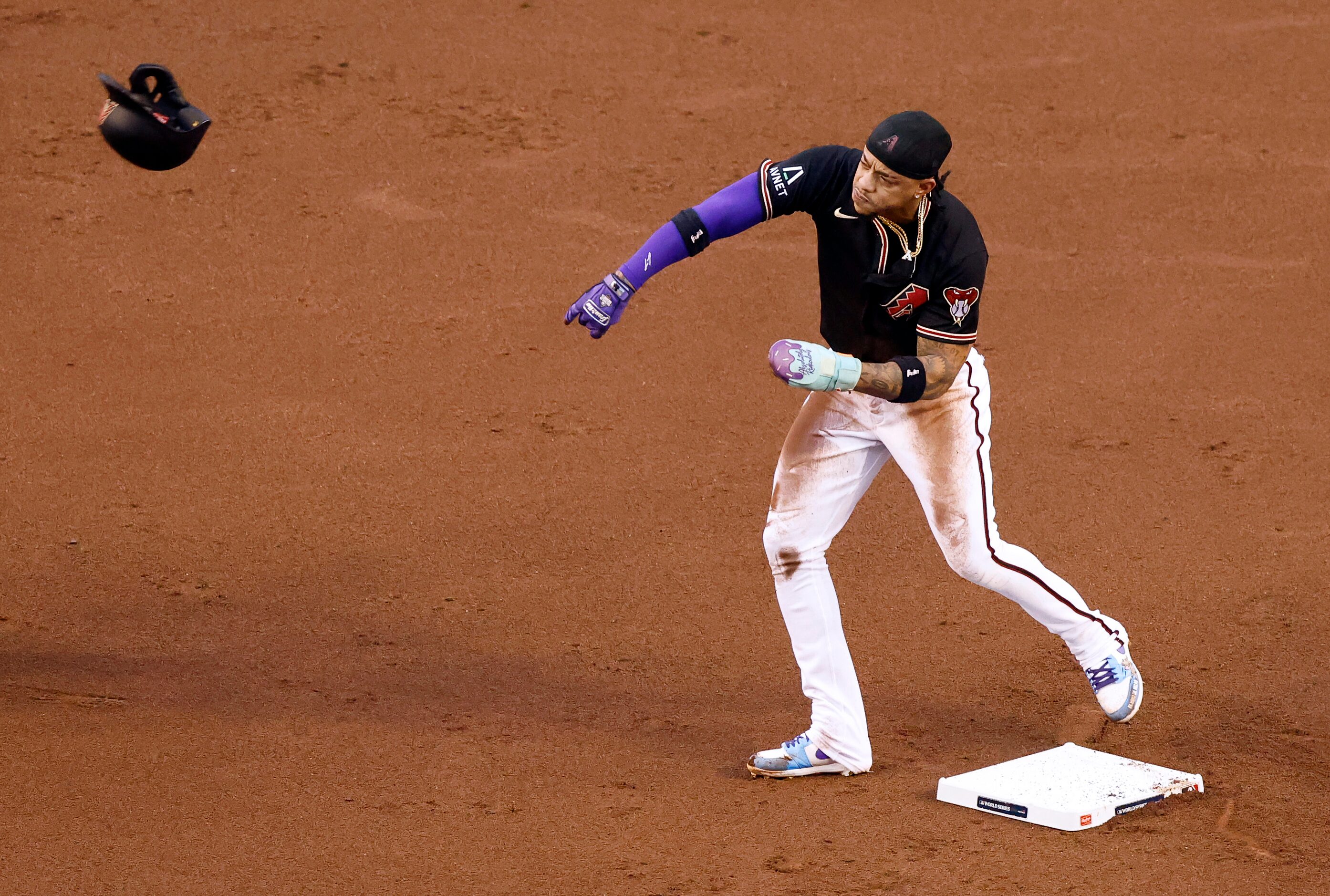 Arizona Diamondbacks’ Ketel Marte throws his helmet in frustration after being tagged out...