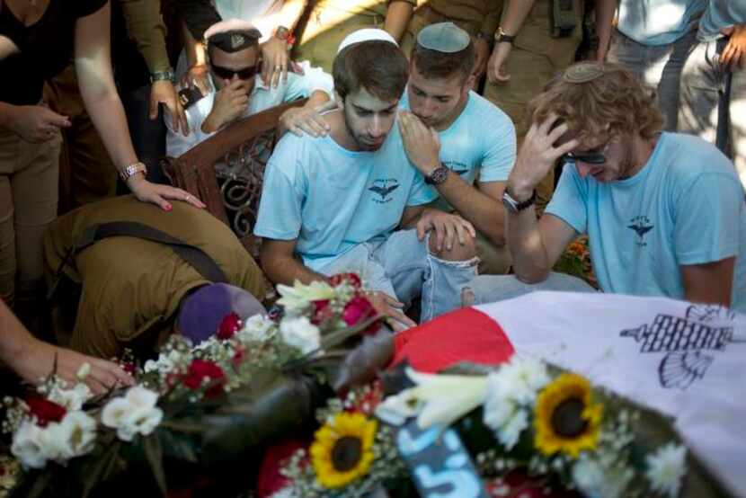 
Israeli mourners gathered Monday at the grave of Capt. Liad Lavi, who died of wounds from...