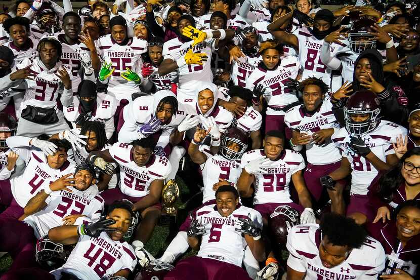 Mansfield Timberview players celebrate with a team photo after a 28-26 victory over Frisco...