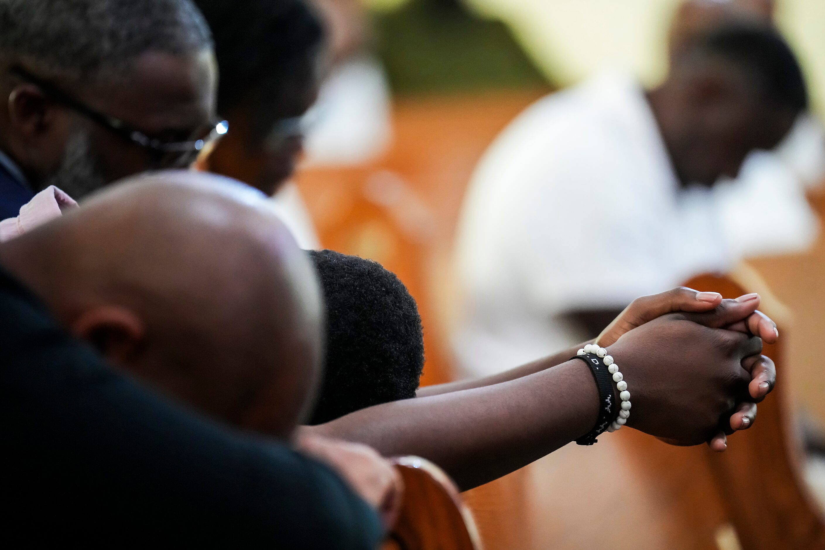 Worshippers pray during a special worship service celebrating the 150th anniversary at St....