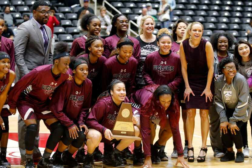 The Mansfield Timberview's Lady Wolves pose with the championship plaque after their 53-47...