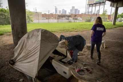  Cindy Crain (left) and Rebecca Cox of the Metro Dallas Homeless Alliance sift through...