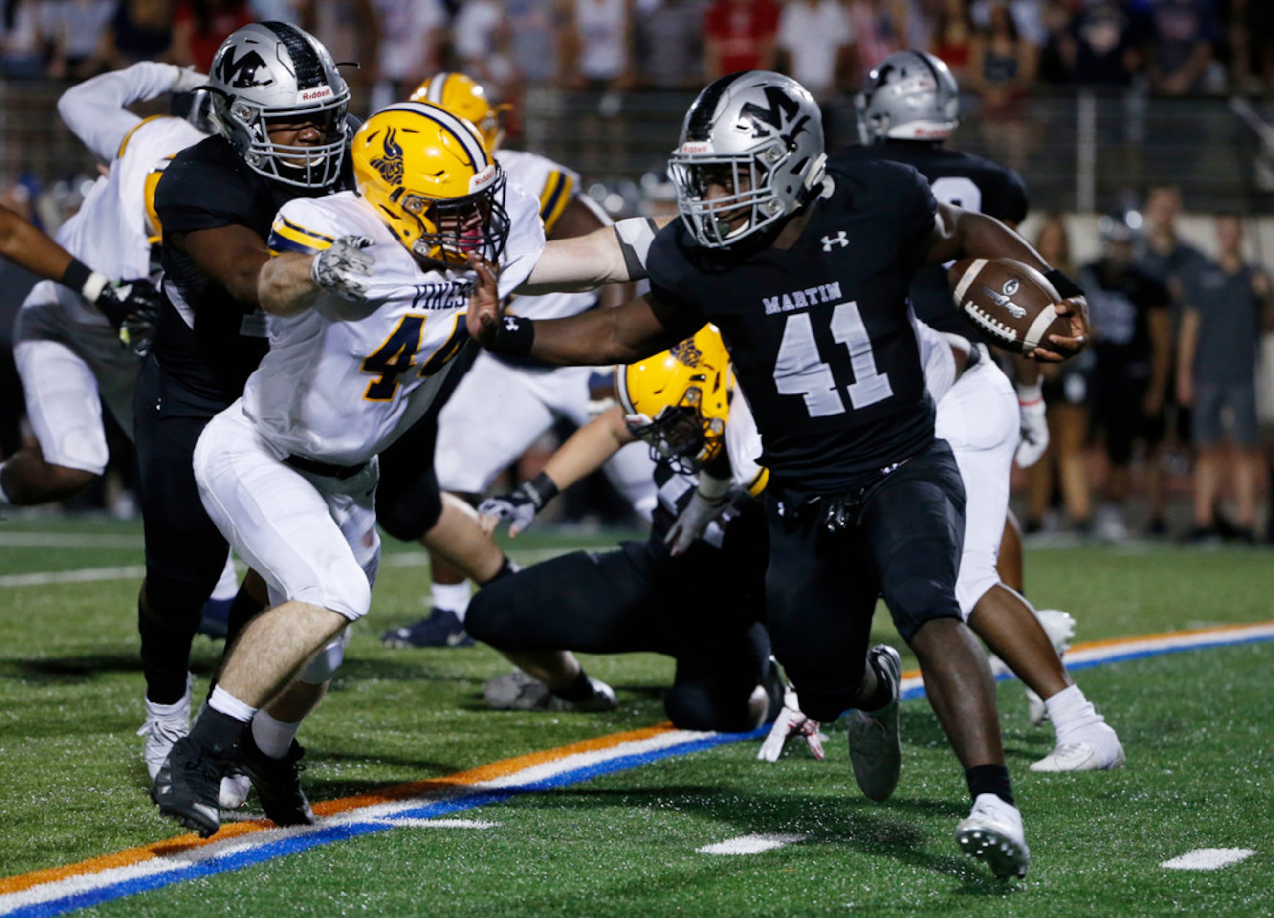 Arlington Lamar's Joey Hartley, (44) attempts to tackle Arlington Martin's Chris Craft (41)...