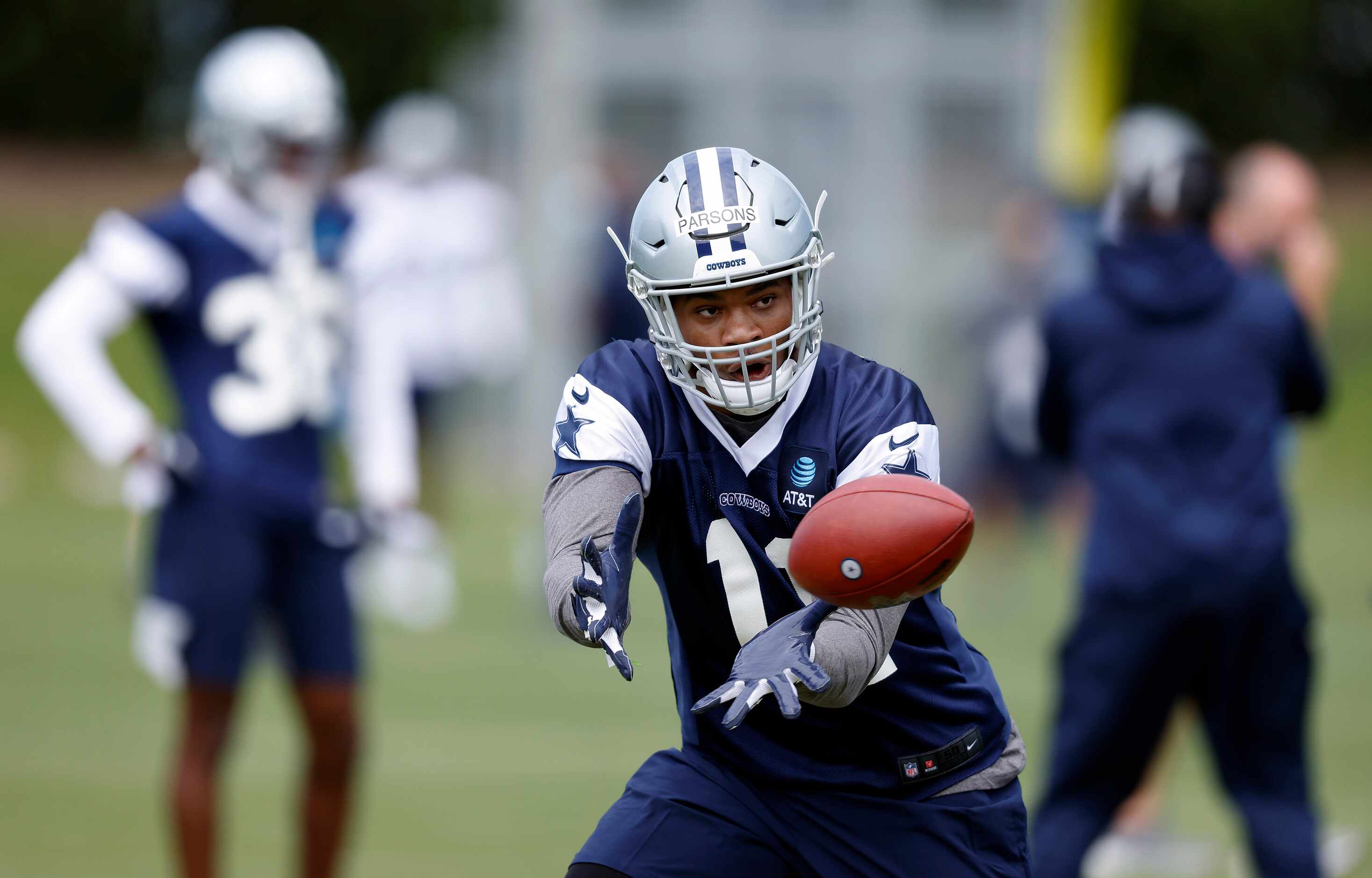 Dallas Cowboys rookie linebacker Micah Parsons (11) catches a pass during rookie minicamp at...