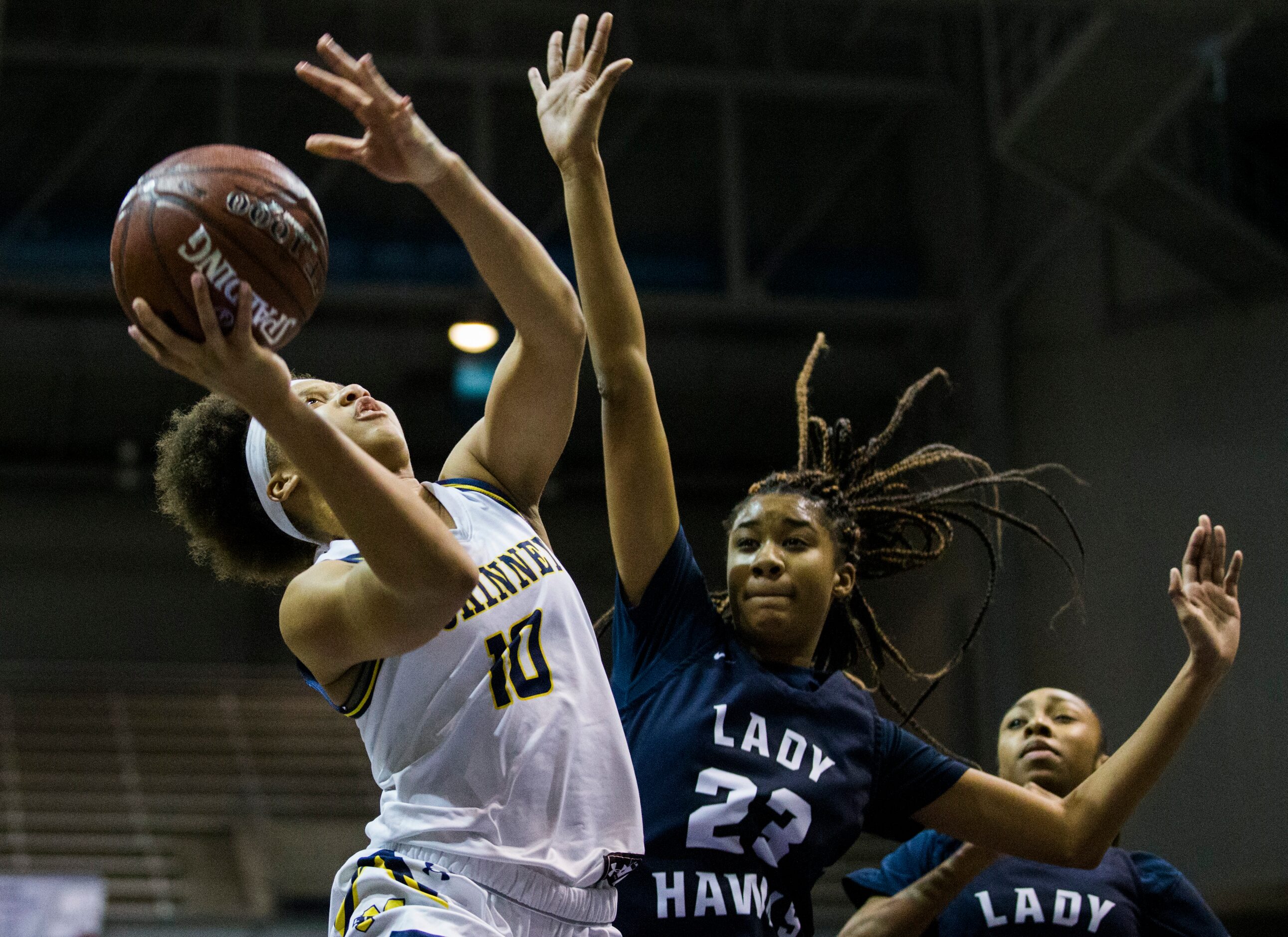 McKinney guard Erin Fry (10) goes up for a shot over Pflugerville Hendrickson center Naomi...