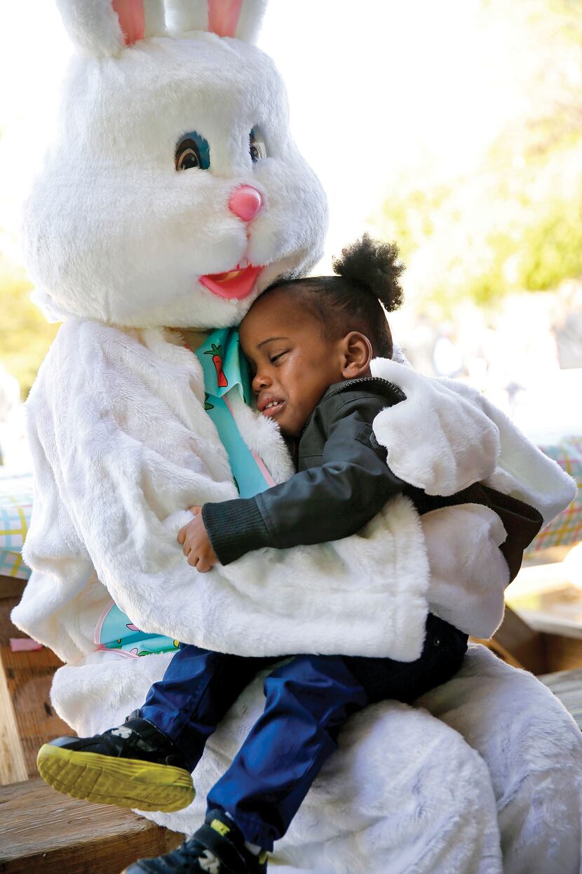 The Easter Bunny comforted Zayne Douglas, 3, of Dallas, a visually impaired boy who was...