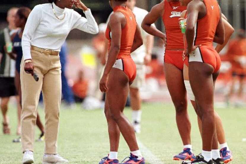 ORG XMIT: S0327897236_STAFF UT track coach Bev Kearney (left) talks strategy with her 4x400m...