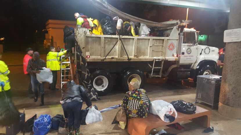 A dump truck pulls into Houston's Kashmere Transit Center with people rescued from Hurricane...