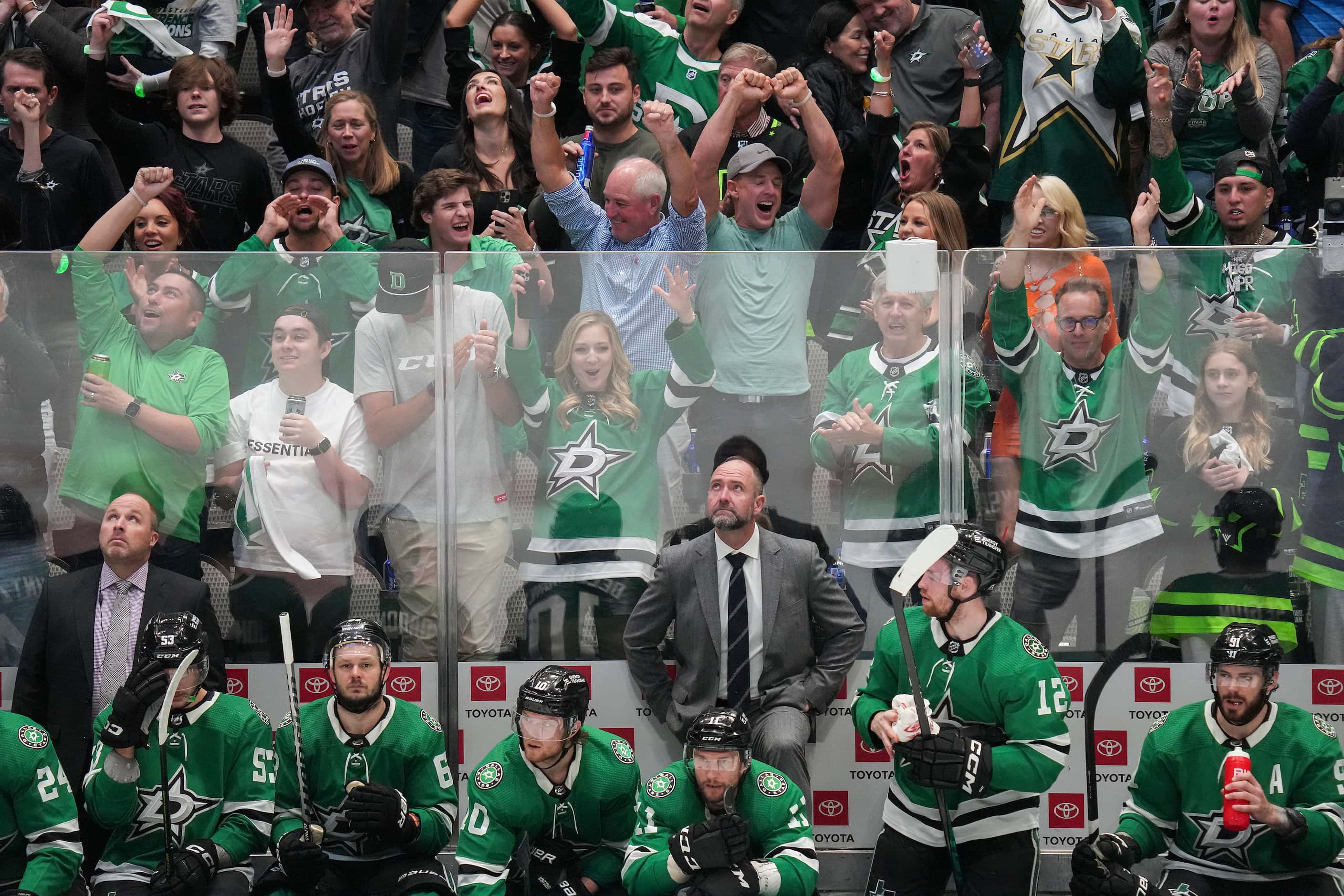 Dallas Stars head coach Pete DeBoer looks up as fans celebrate a goal by center Roope Hintz...