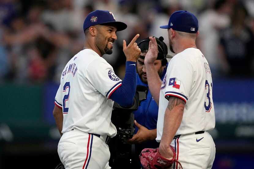 Texas Rangers' Marcus Semien, left, and Kirby Yates, right, celebrate after their win over...