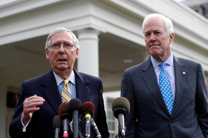 Senate Majority Leader Mitch McConnell (left) and Majority Whip Sen. John Cornyn speak with...