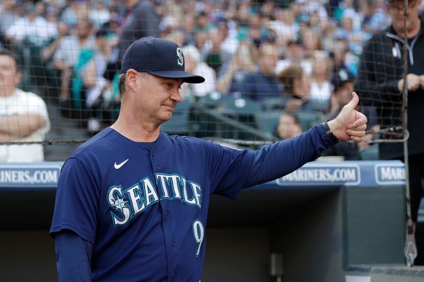 Seattle Mariners manager Scott Servais gives a thumbs up to a fan before a baseball game...