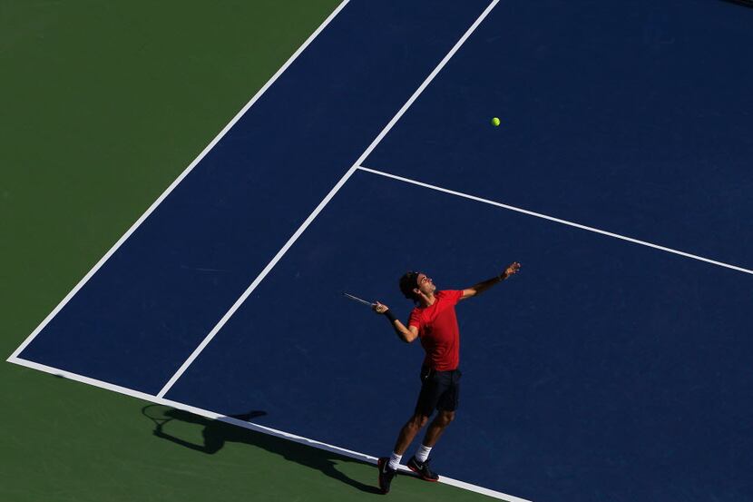 NEW YORK, NY - AUGUST 26: Roger Federer of Switzerland serves while practicing prior to the...