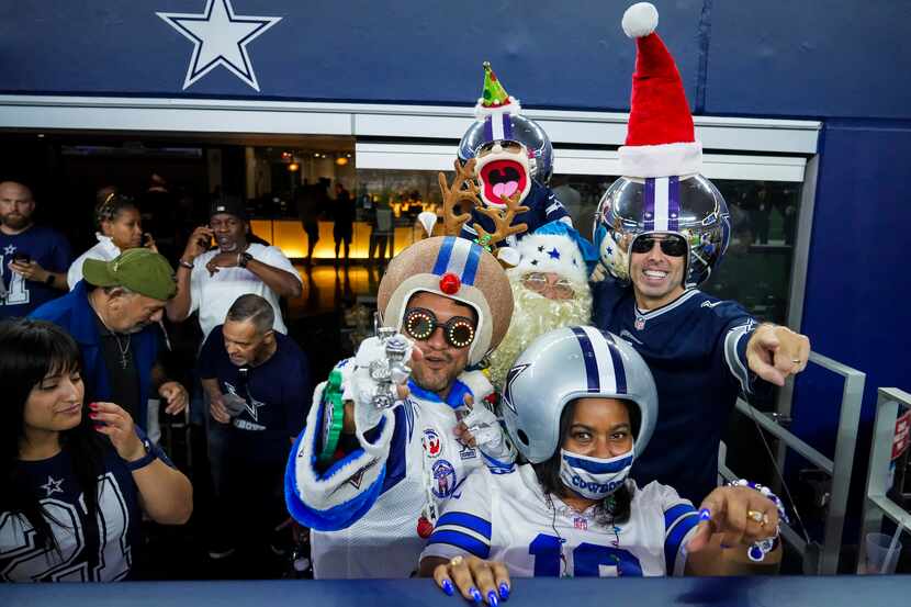 Dallas Cowboys fans cheer as the team warms up before an NFL football game against the...