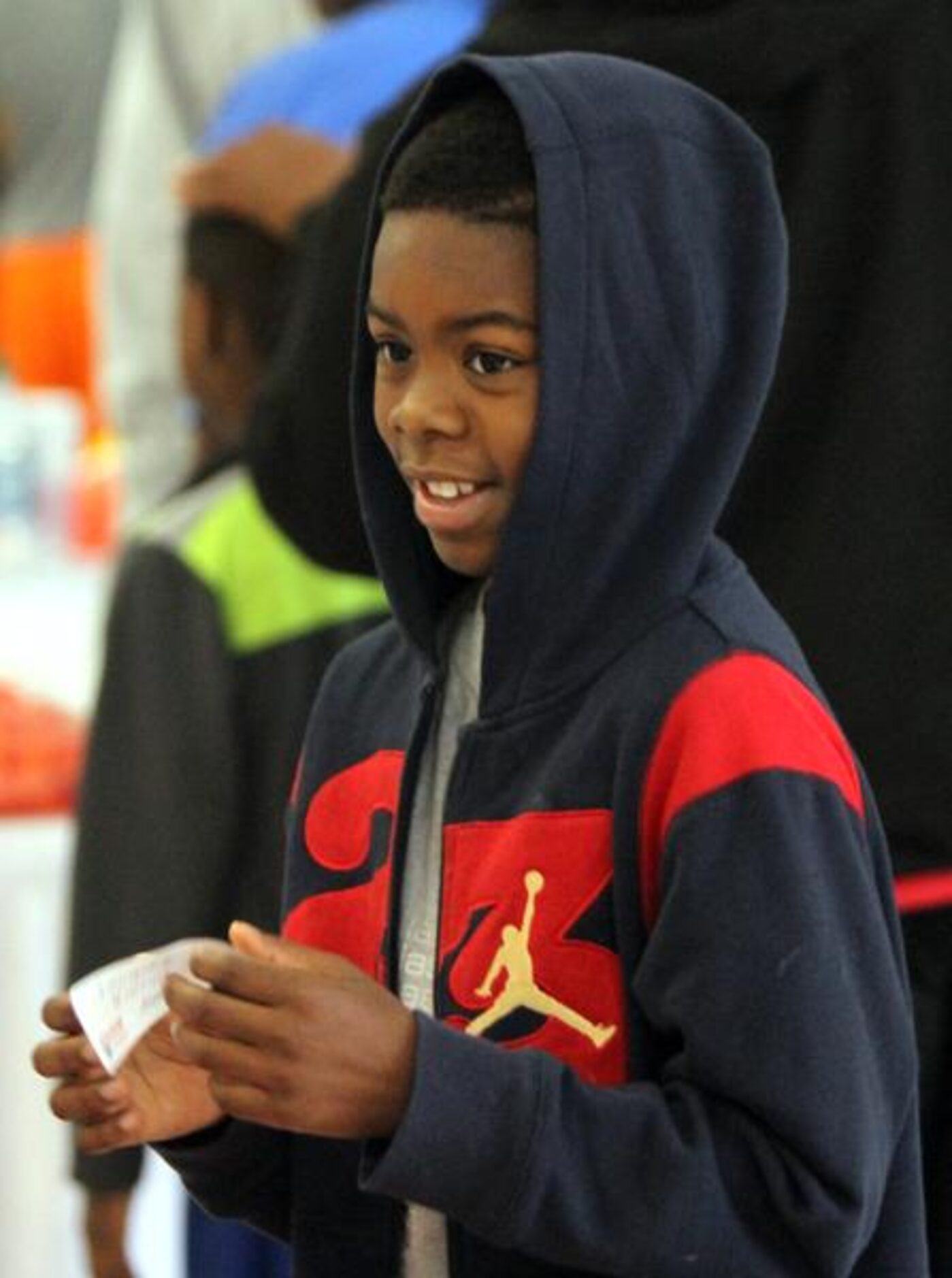 
Jacquez Ramey, 11, was all smiles after receiving his name tag at the registration table....