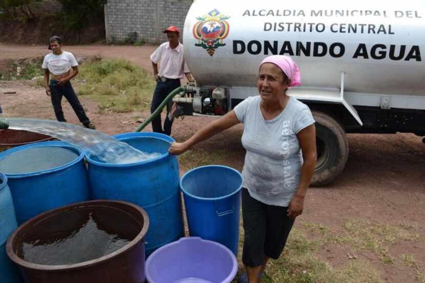 
A tanker filled containers with water in a poor neighborhood outside Tegucigalpa in early...