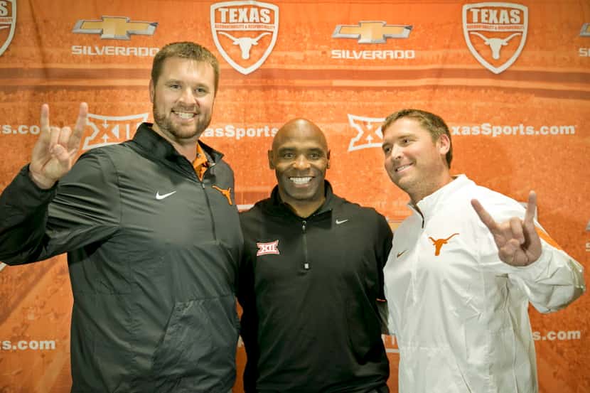University of Texas NCAA college football head coach Charlie Strong, center, introduces two...