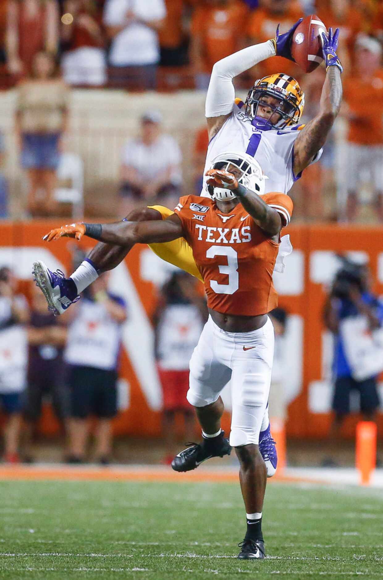 LSU Tigers wide receiver Ja'Marr Chase (1) lands a pass over Texas Longhorns defensive back...