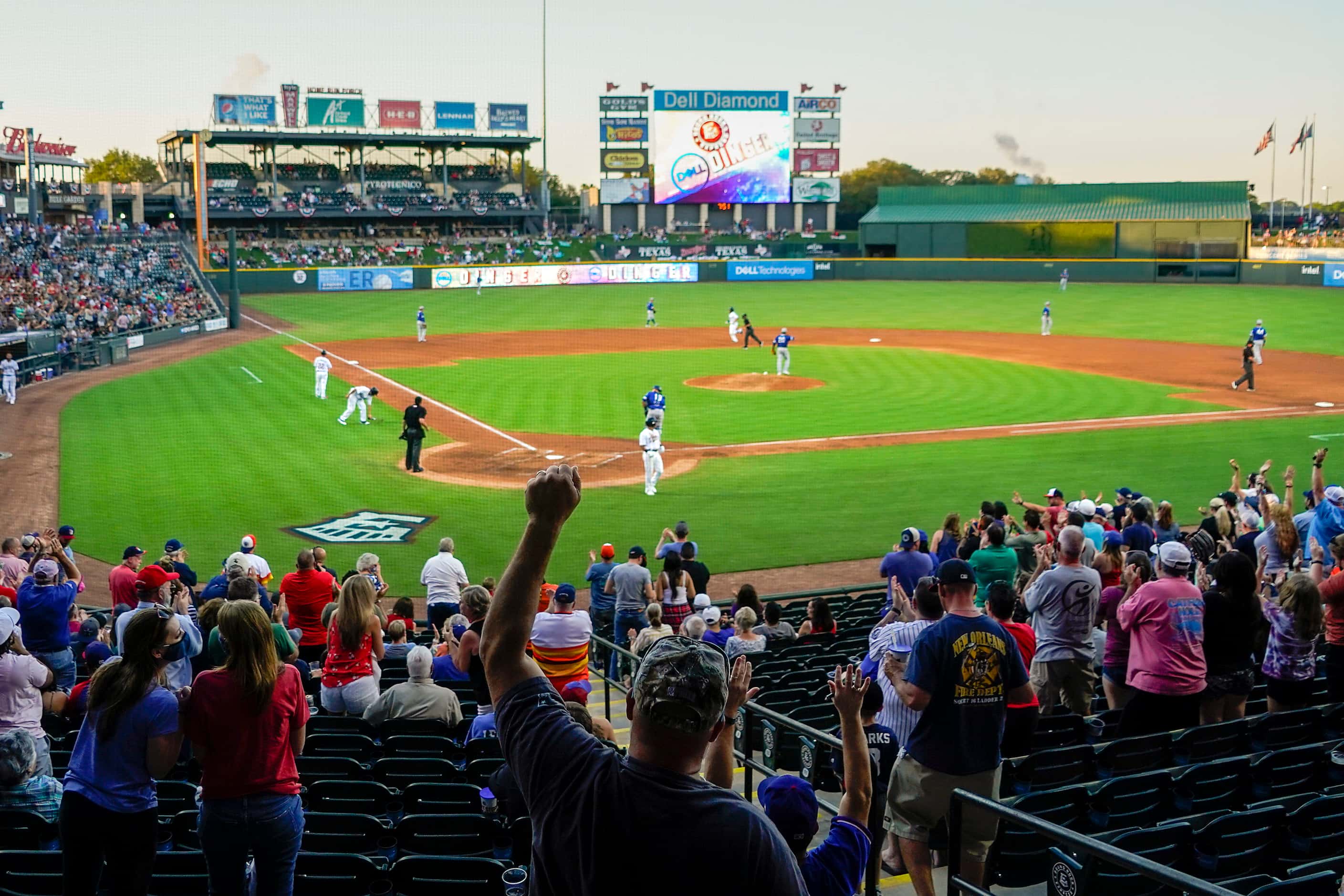Fans cheer a 2-run home run by Round Rock Express infielder Charles Leblanc during the...