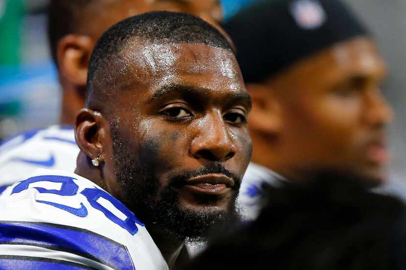 Dallas Cowboys wide receiver Dez Bryant (88) and his teammates rest on the bench in the...