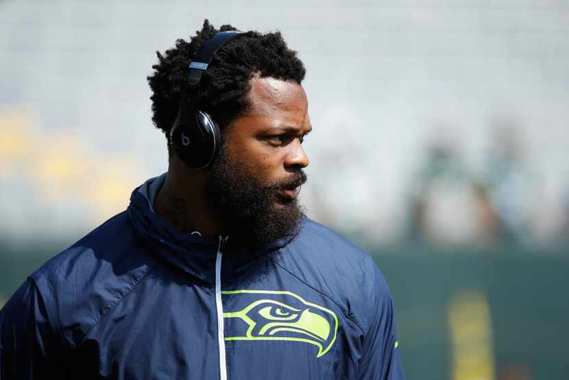 GREEN BAY, WI - SEPTEMBER 10:  Michael Bennett #72 of the Seattle Seahawks looks on before...