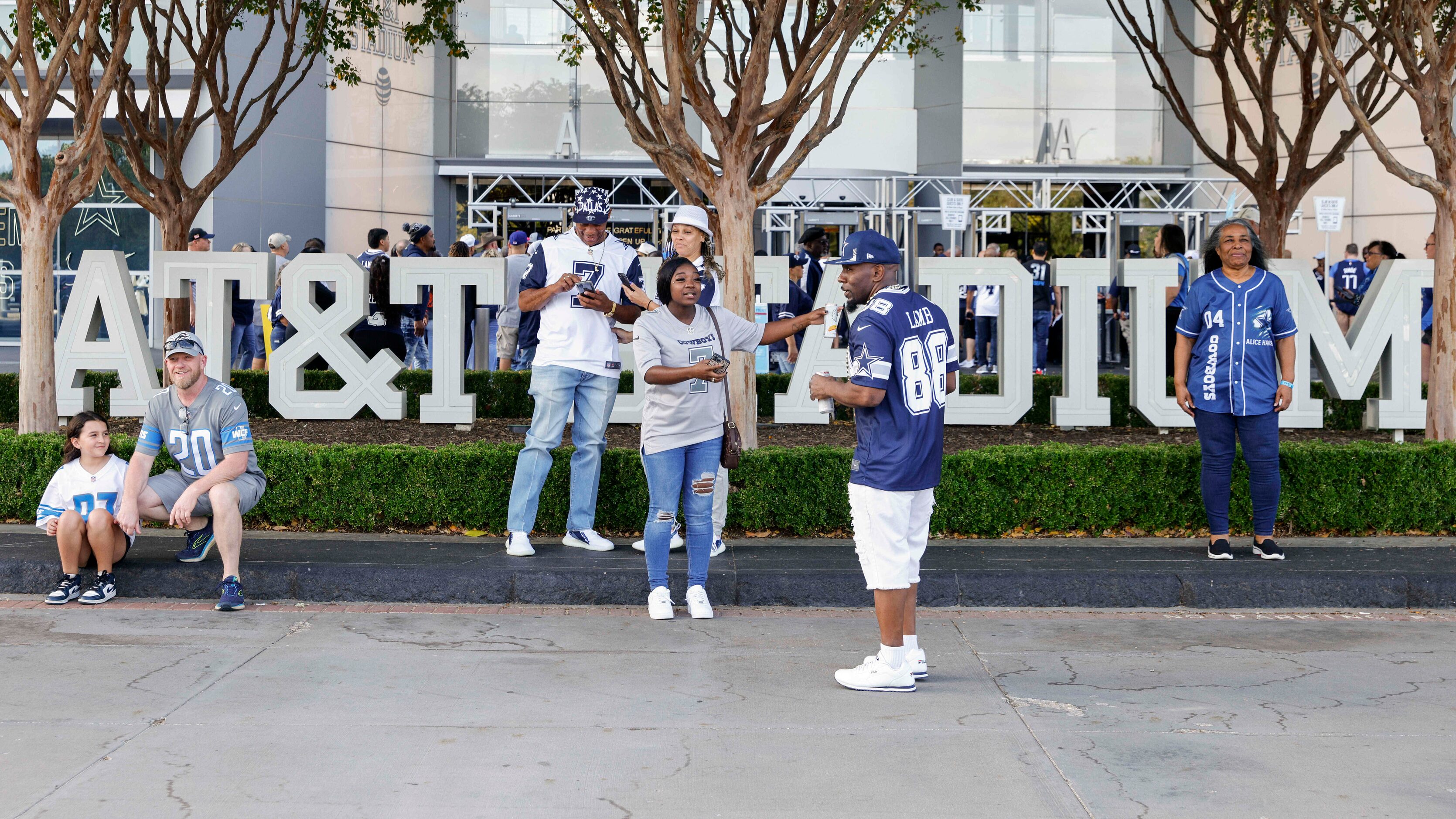 People pose for photos outside AT&T Stadium before a Dallas Cowboys and Detroit Lions game...