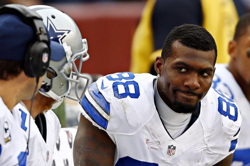 Dallas Cowboys wide receiver Dez Bryant (88) frowns as he talks with quarterback Tony Romo...