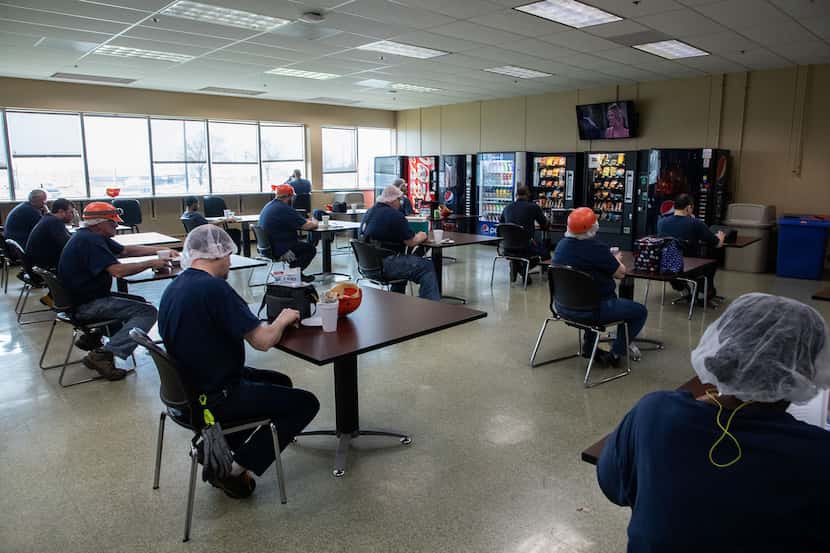 Workers practice social distancing during lunch break at the Kraft Heinz manufacturing plant.