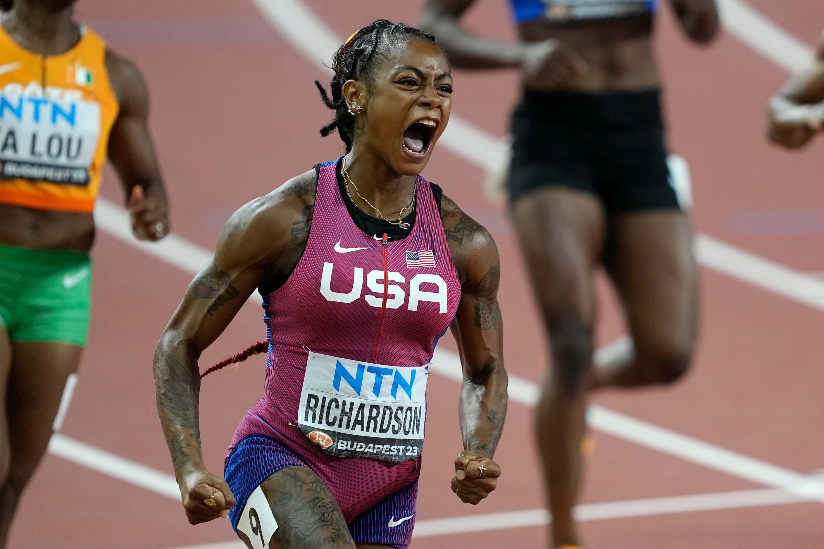 Sha'Carri Richardson, of the United States, celebrates her gold medal after crossing the...