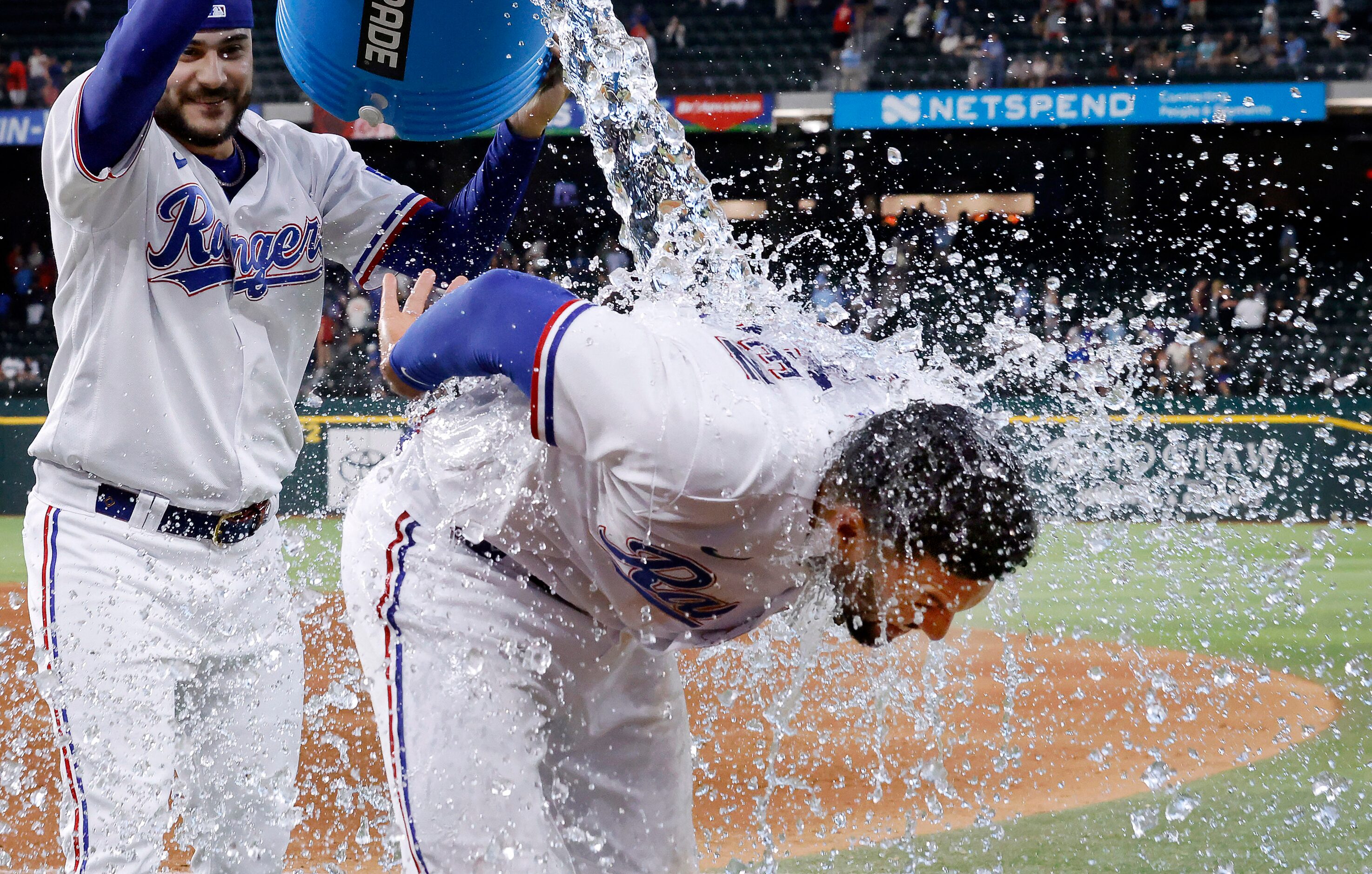 After the game, Texas Rangers second baseman Marcus Semien (2) receives an ice bath from...