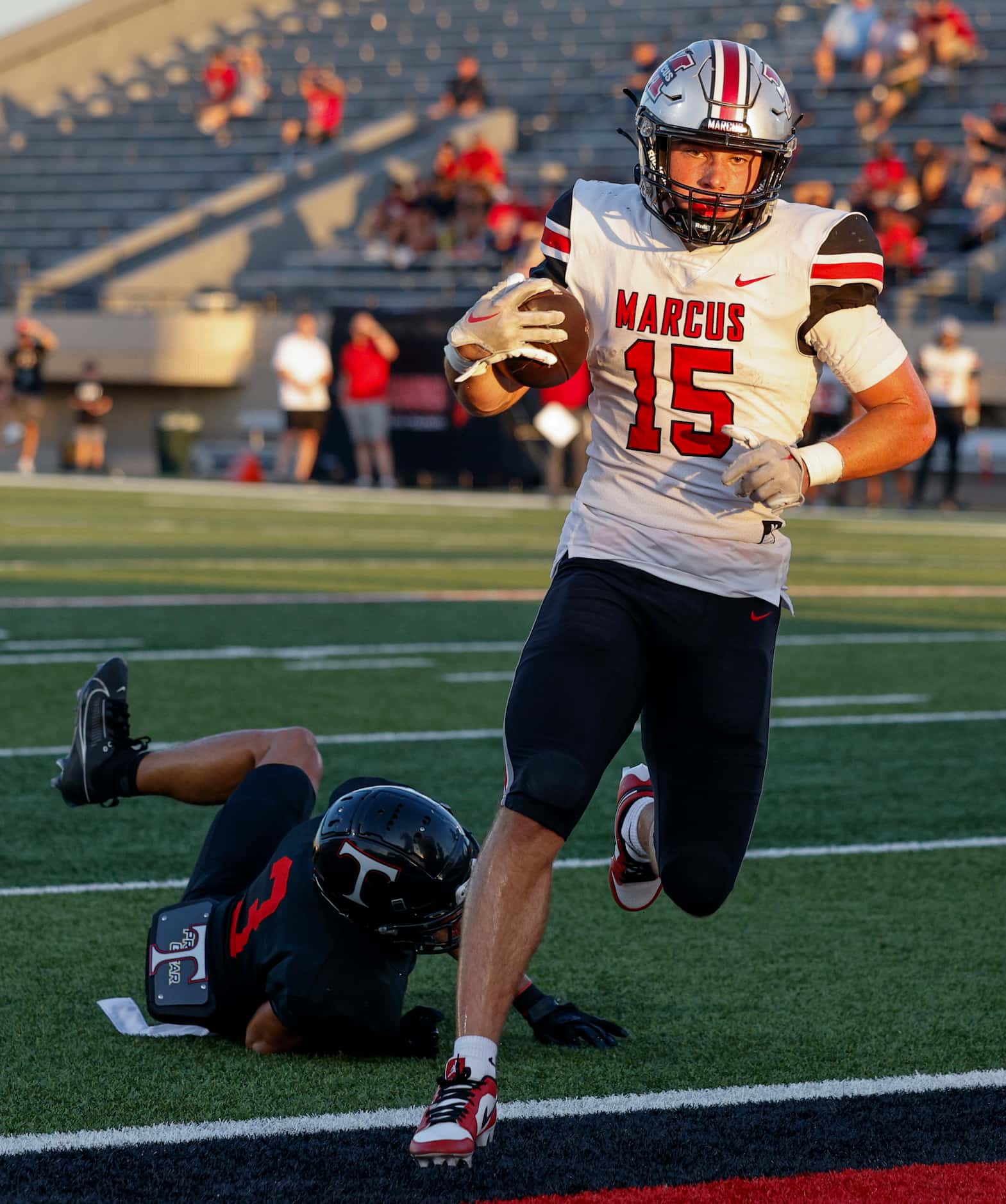 Flower Mound Marcus quarterback Brock Golwas (15) runs for a touchdown past Euless Trinity...
