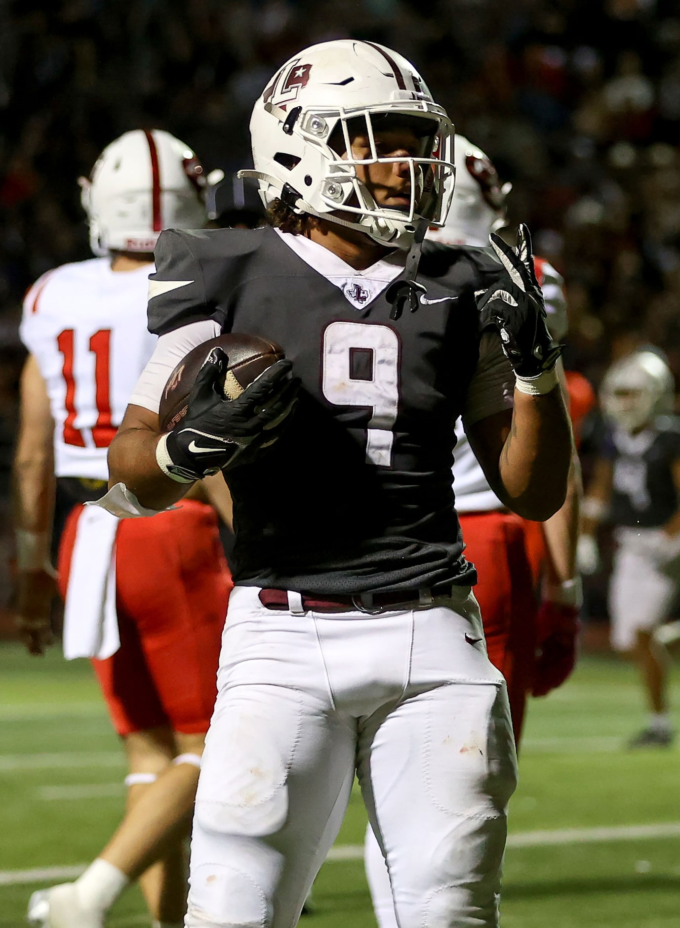 Lewisville running back Tenel Hill (9) poses after scoring a touchdown against Coppell...