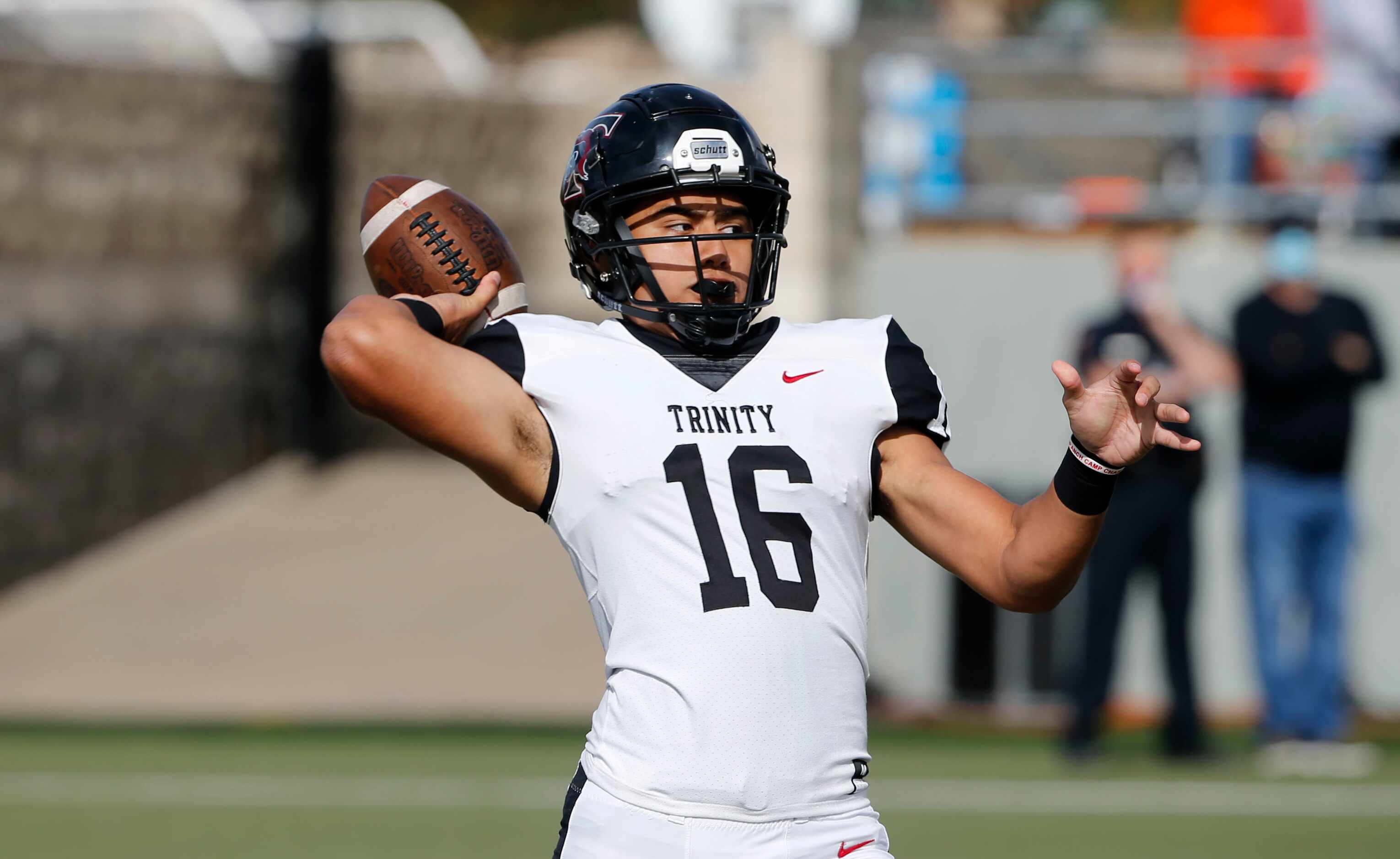 Euless Trinity quarterback Valentiono Foni (16) throws a pass against Haltom during their...