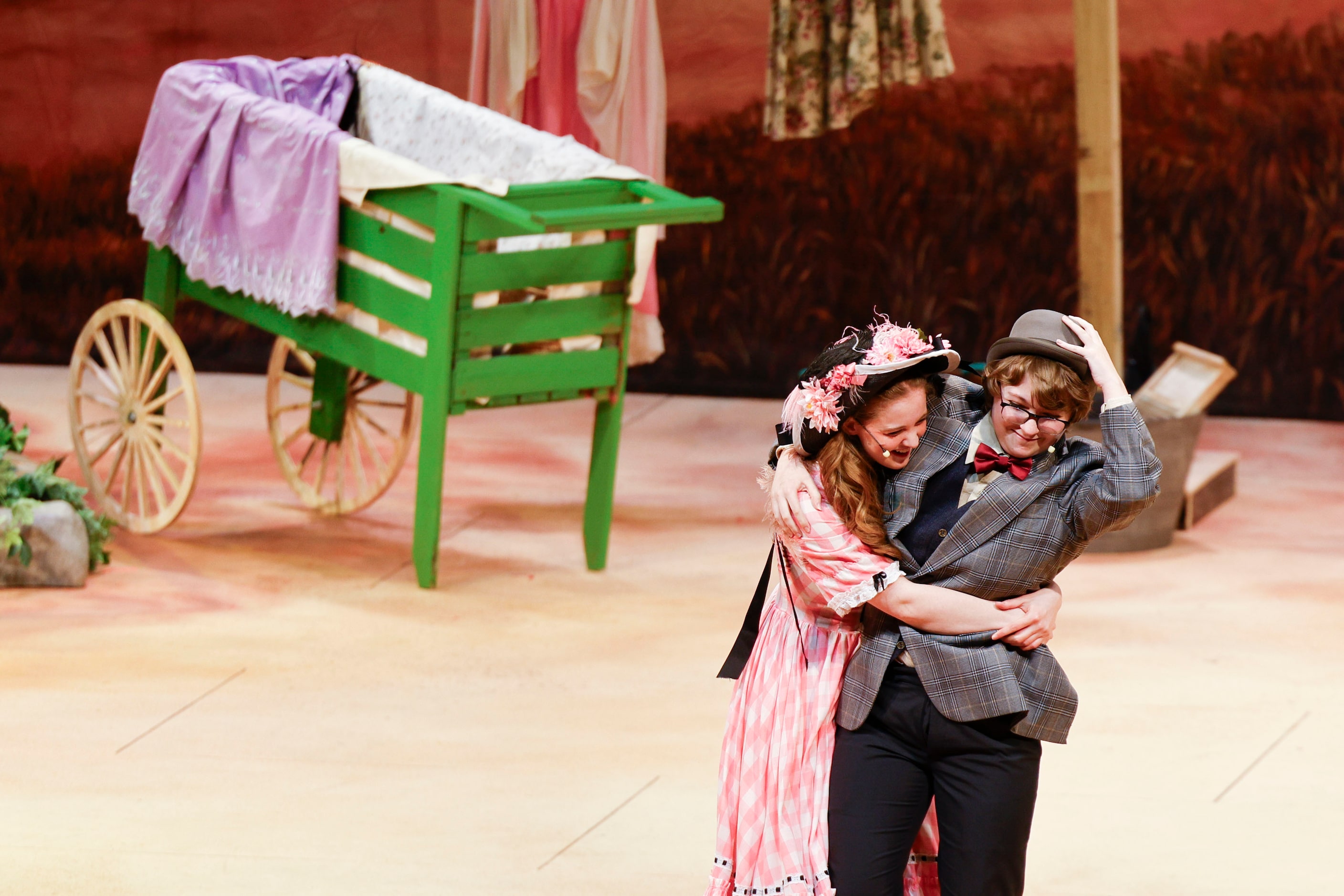 Cast member Max Hightower (right) as Ali Hakim, and Avery Tollison as Ado Annie act during...