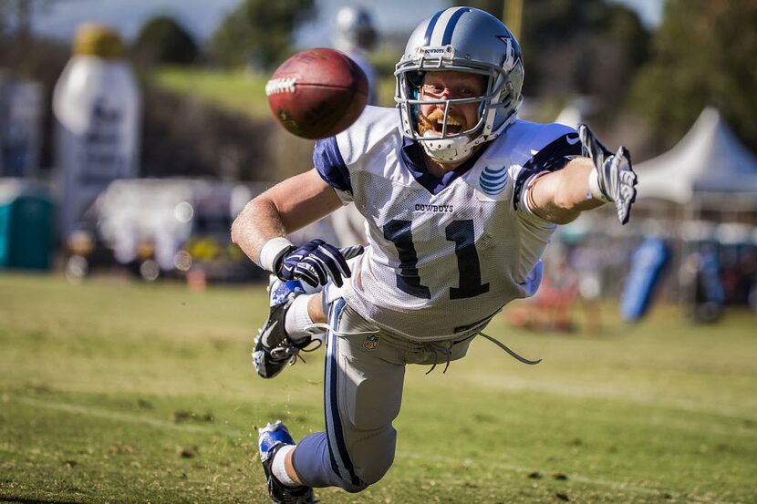 Dallas Cowboys wide receiver Cole Beasley dives for a pass during afternoon practice at...