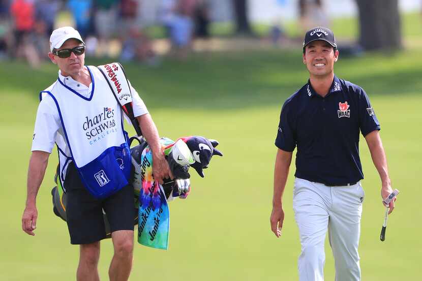 FORT WORTH, TEXAS - MAY 26:  Kevin Na of the United States and caddie, Kenny Harms, walk up...