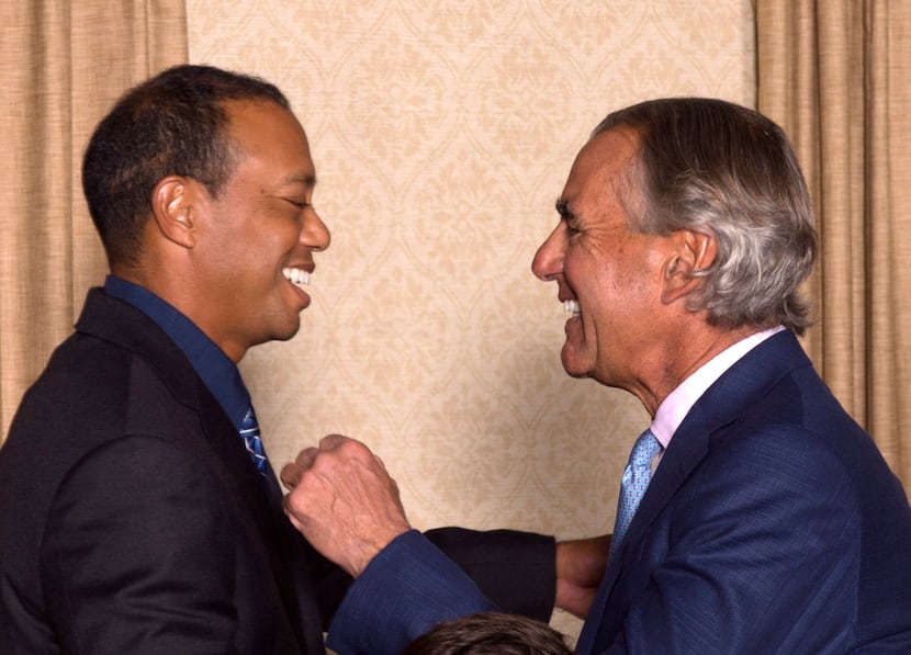 Tiger Woods greeted PGA of America CEO Seth Waugh during the champion's dinner for the 101st...
