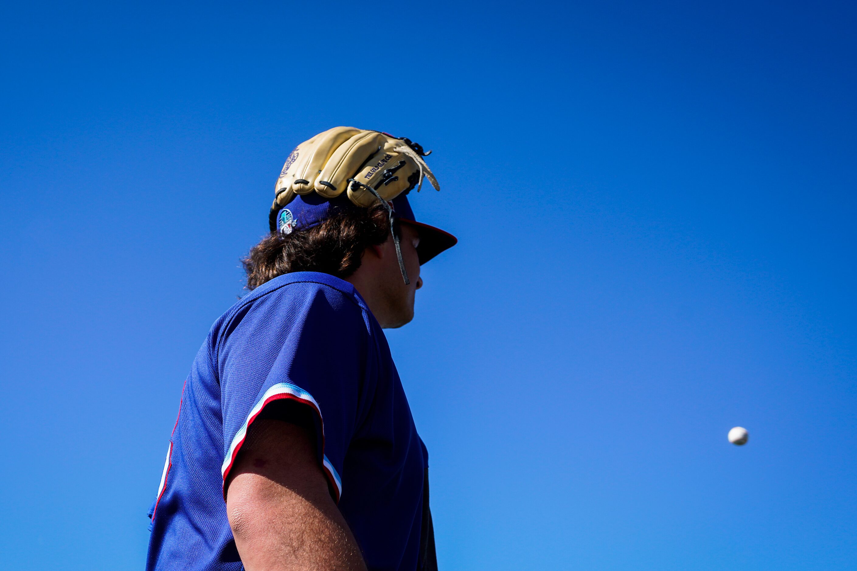 Texas Rangers pitcher Ian Gibaut walks between drills during a spring training workout at...