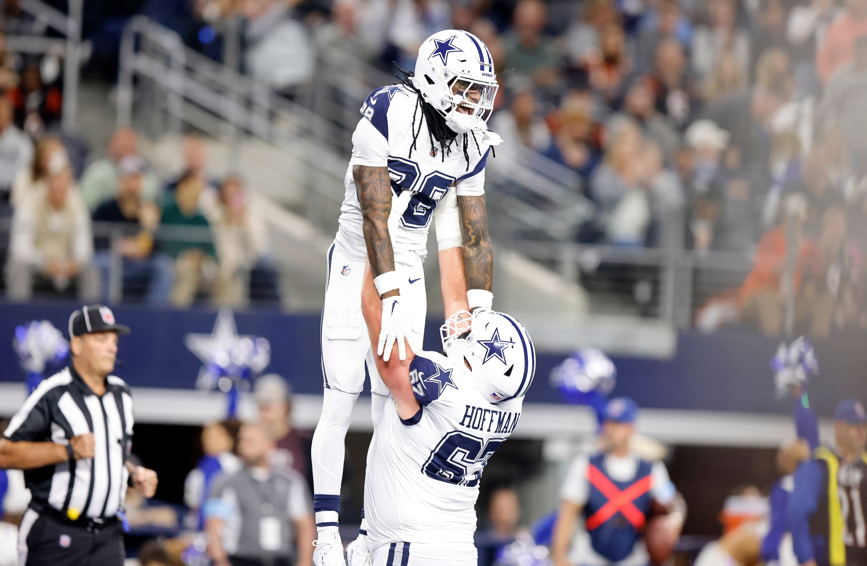 Dallas Cowboys wide receiver CeeDee Lamb (88) is hoisted in the air by center Brock Hoffman...