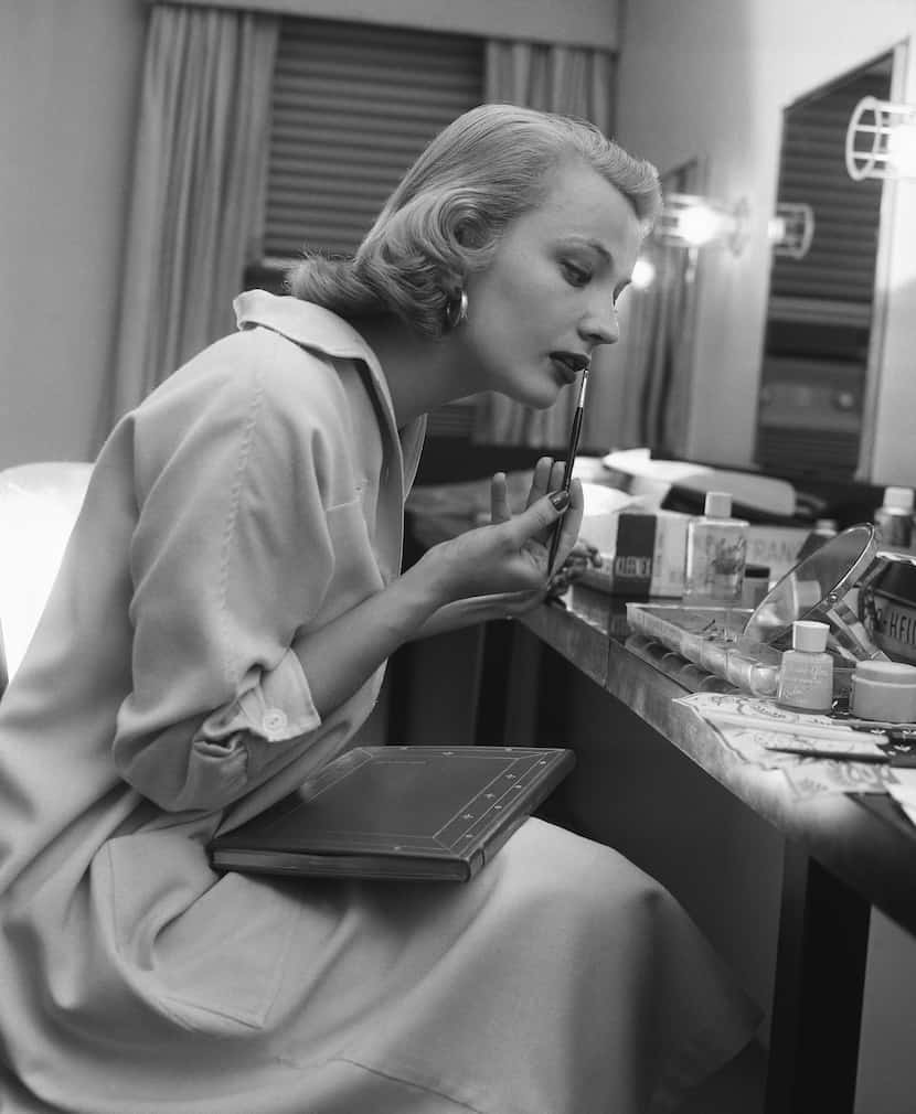 Actor Gena Rowlands, puts on make-up in her dressing room for her role as leading lady in...