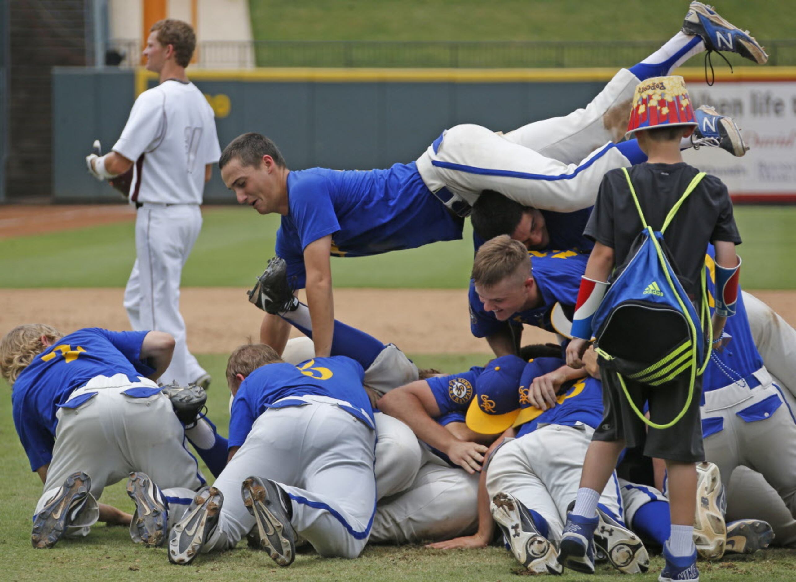 Sunnyvale's Jake Wilcox, top, joins the pile as he and his teammates celebrate their 13-3...